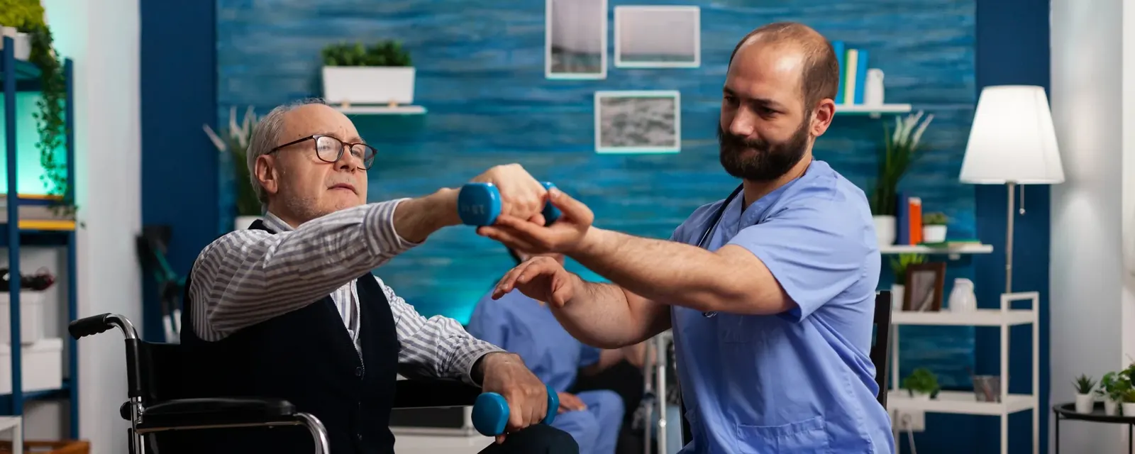 A practitioner guiding a seated patient through light dumbbell exercises during rehabilitation