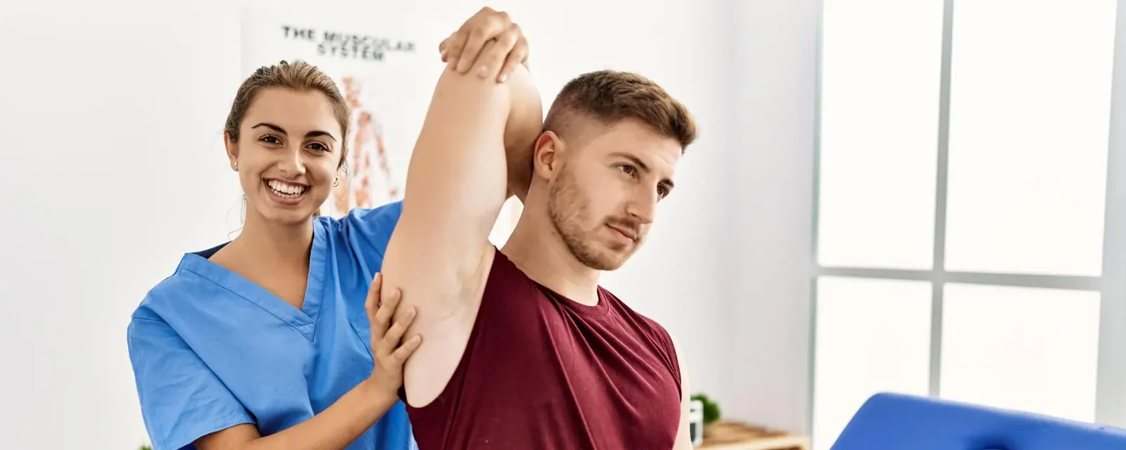 A clinician guiding a patient through a shoulder range-of-movement assessment